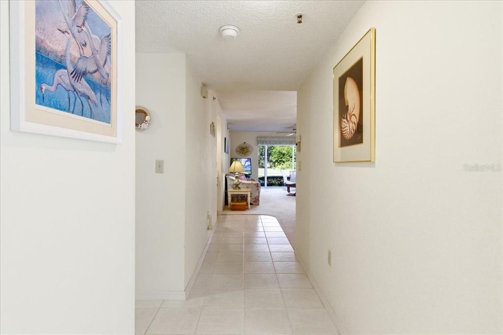 6713 Stone River Road, Unit 103 Bradenton, FL 34203 - Photo 12 of 86 a view of a hallway with a dining area