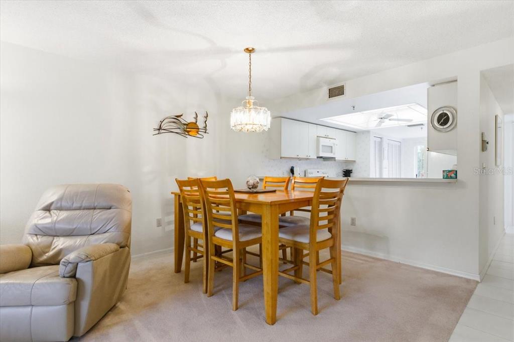 6713 Stone River Road, Unit 103 Bradenton, FL 34203 - Photo 17 of 86 a dining room with furniture and window