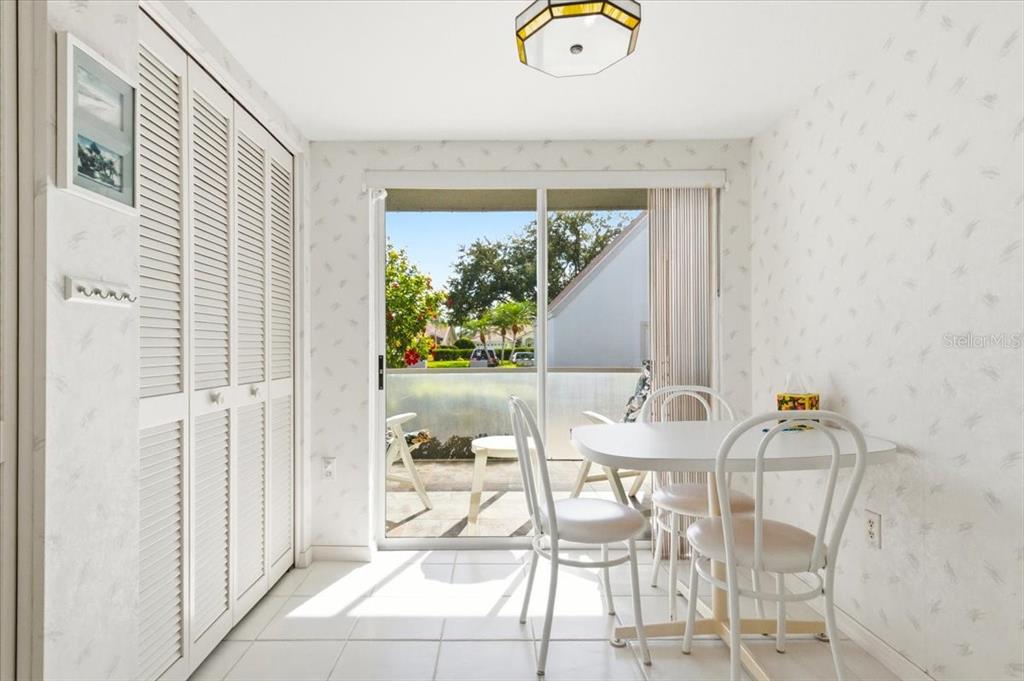 6713 Stone River Road, Unit 103 Bradenton, FL 34203 - Photo 25 of 86 a view of a dining room with furniture and a floor to ceiling window