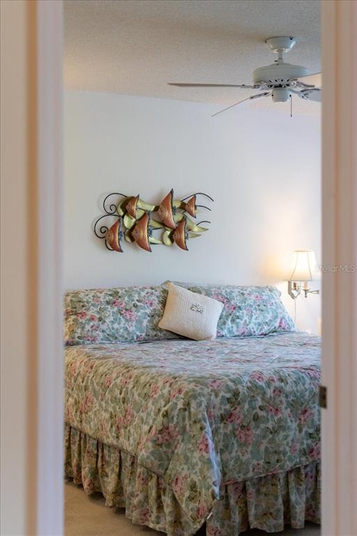 6713 Stone River Road, Unit 103 Bradenton, FL 34203 - Photo 28 of 86 a bedroom with a bed and a table in it