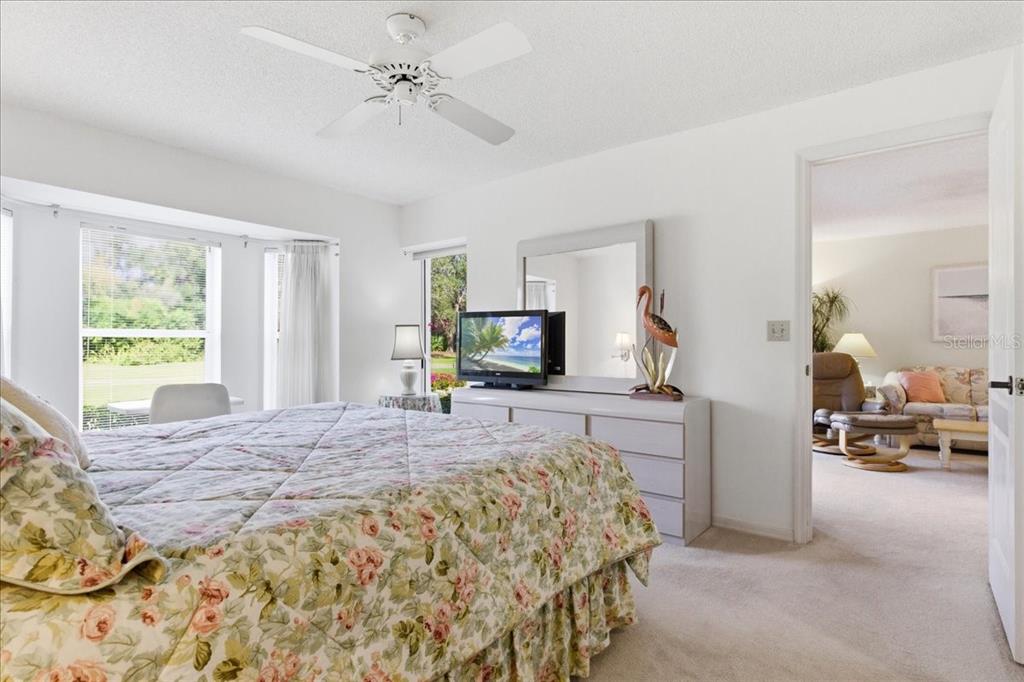 6713 Stone River Road, Unit 103 Bradenton, FL 34203 - Photo 29 of 86 a bedroom with a bed and a flat screen tv