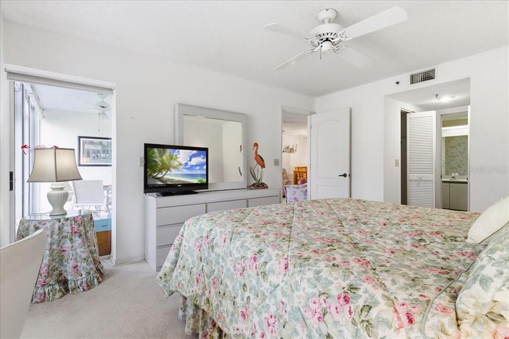 6713 Stone River Road, Unit 103 Bradenton, FL 34203 - Photo 31 of 86 a bedroom with a bed and a flat screen tv