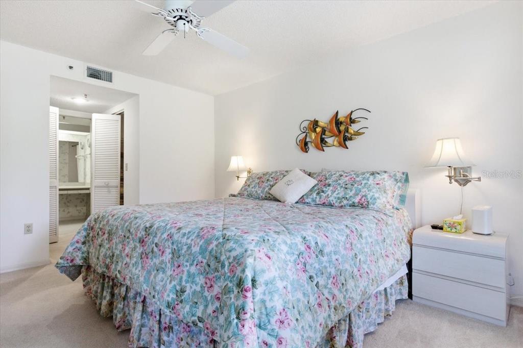 6713 Stone River Road, Unit 103 Bradenton, FL 34203 - Photo 33 of 86 a bedroom with a bed and a chandelier