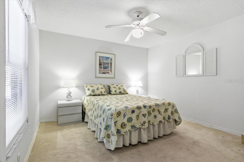 6713 Stone River Road, Unit 103 Bradenton, FL 34203 - Photo 38 of 86 a bedroom with a bed and a chandelier