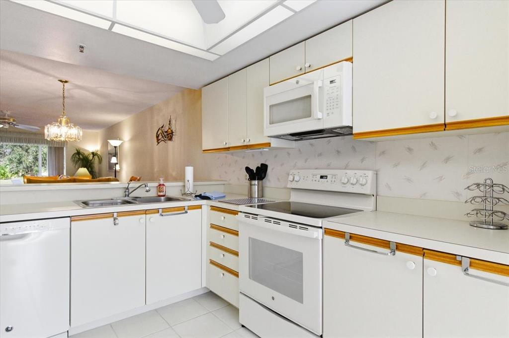 6713 Stone River Road, Unit 103 Bradenton, FL 34203 - Photo 4 of 86 a kitchen with cabinets appliances and a sink