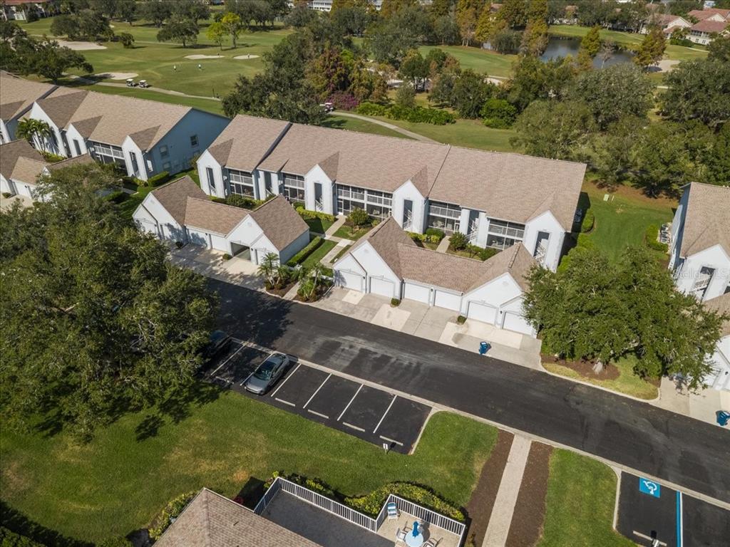 6713 Stone River Road, Unit 103 Bradenton, FL 34203 - Photo 58 of 86 an aerial view of a house with a garden and lake view