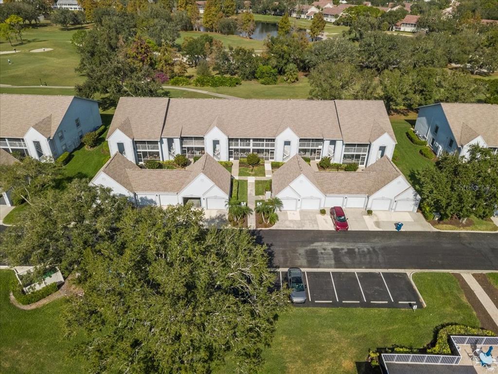 6713 Stone River Road, Unit 103 Bradenton, FL 34203 - Photo 60 of 86 an aerial view of a house with swimming pool and lake view