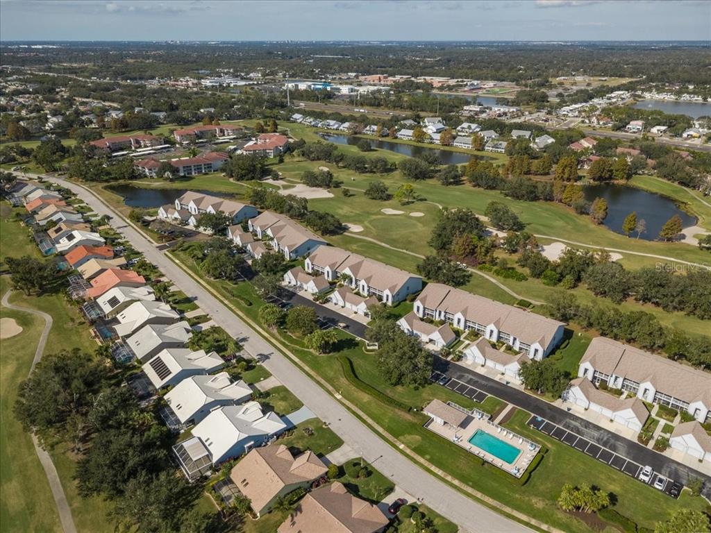 6713 Stone River Road, Unit 103 Bradenton, FL 34203 - Photo 63 of 86 an aerial view of residential houses with outdoor space