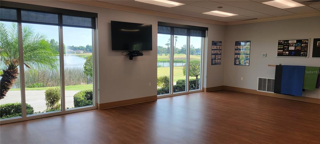 6713 Stone River Road, Unit 103 Bradenton, FL 34203 - Photo 77 of 86 a view of an empty room with wooden floor and a window