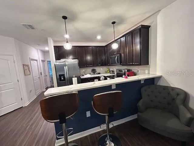 a living room with furniture and kitchen view