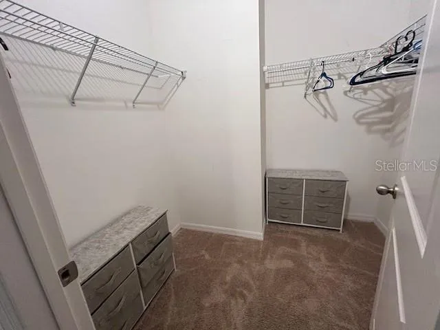 a bedroom with a bed and flat screen tv