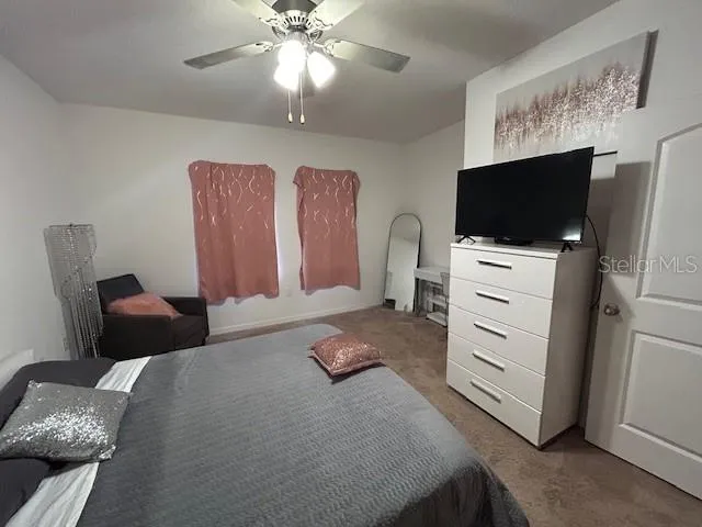 a en suite bathroom with a shower sink and mirror
