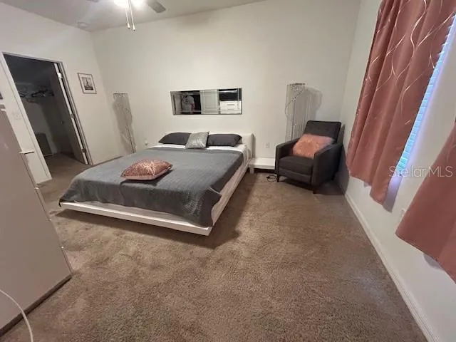 a bedroom with a bed and a mirror