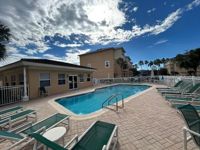a view of a swimming pool with lounge chair