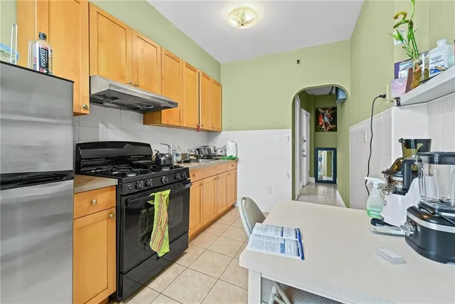 a kitchen with stainless steel appliances granite countertop a sink and a stove
