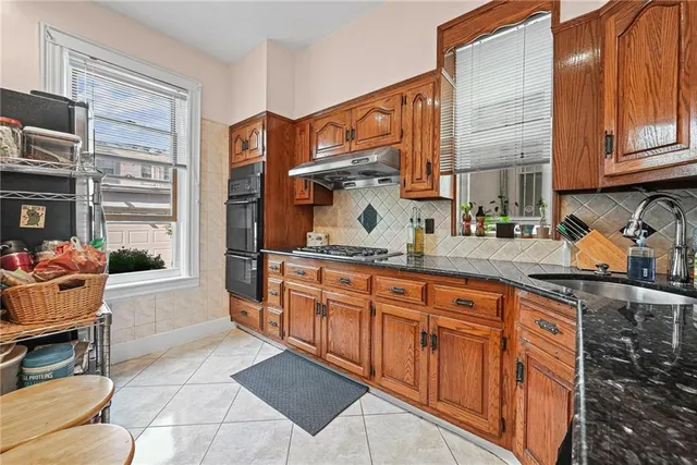 a kitchen with stainless steel appliances granite countertop a sink and cabinets