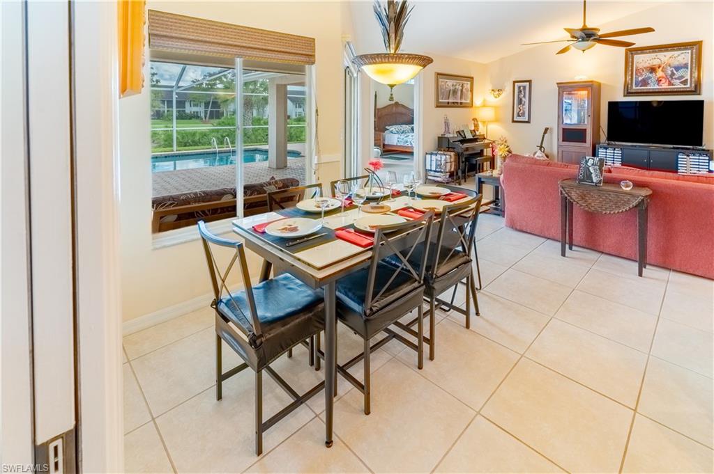 458 Countryside Drive Naples, FL 34104 - Photo 12 of 50 Dining room with light tile patterned floors, a ceiling fan, and a sunroom