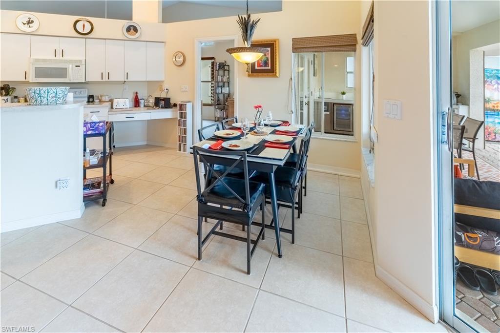 458 Countryside Drive Naples, FL 34104 - Photo 13 of 50 Dining space with light tile patterned floors and wine cooler