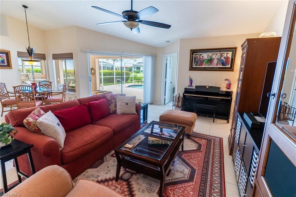 458 Countryside Drive Naples, FL 34104 - Photo 15 of 50 Living room featuring light tile patterned floors, lofted ceiling, and ceiling fan