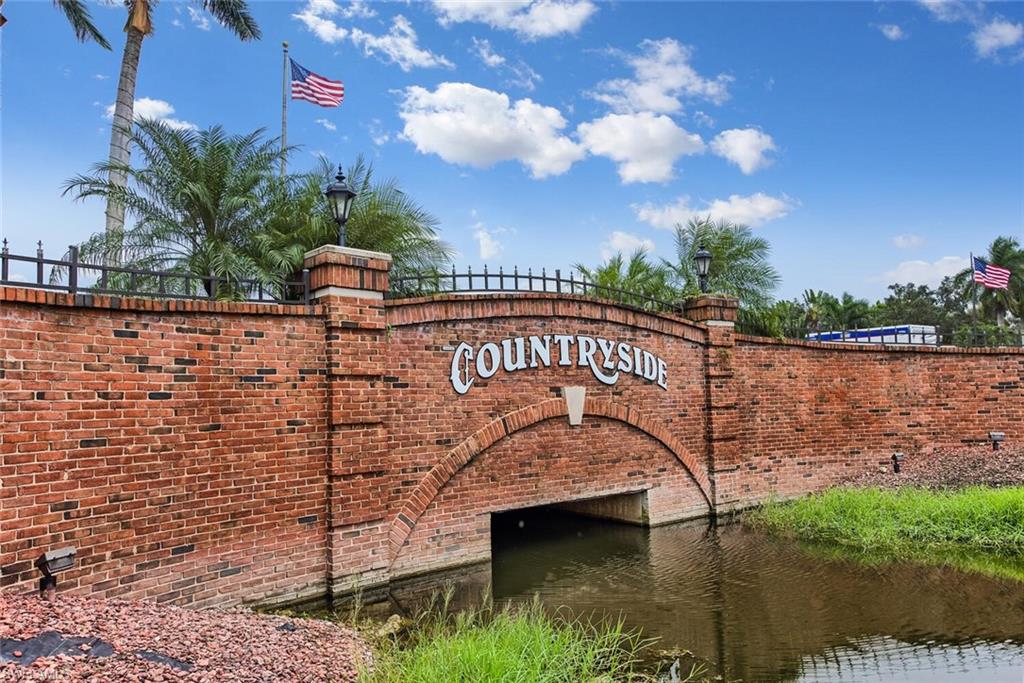 458 Countryside Drive Naples, FL 34104 - Photo 2 of 50 Community / neighborhood sign featuring a water view