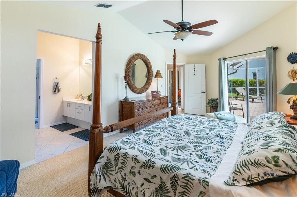 458 Countryside Drive Naples, FL 34104 - Photo 21 of 50 Bedroom featuring lofted ceiling, access to exterior, light carpet, a ceiling fan, and light tile patterned floors