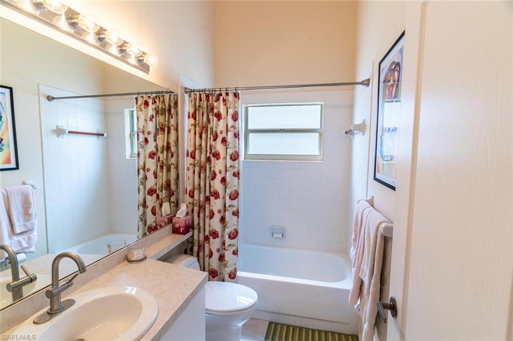 458 Countryside Drive Naples, FL 34104 - Photo 30 of 50 Full bathroom featuring shower / bathtub combination with curtain and vanity