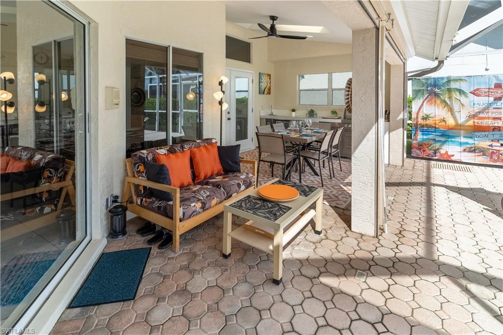 458 Countryside Drive Naples, FL 34104 - Photo 39 of 50 View of patio / terrace featuring outdoor dining area, ceiling fan, and an outdoor hangout area