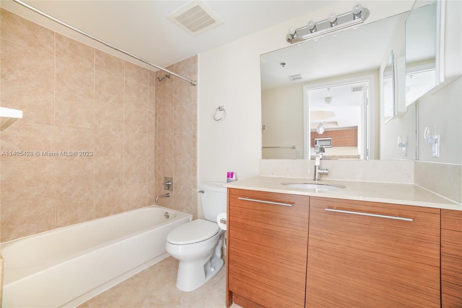2681 North Flamingo Road, Unit 1906S Sunrise, FL 33323 - Photo 11 of 16 a bathroom with a sink a toilet and shower