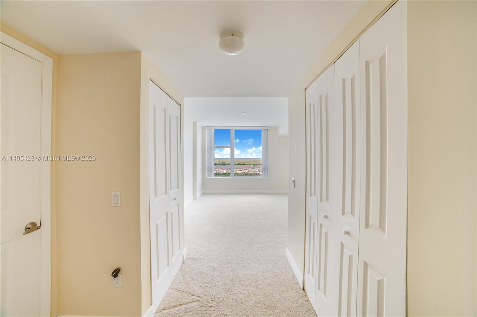 2681 North Flamingo Road, Unit 1906S Sunrise, FL 33323 - Photo 14 of 16 a view of a hallway with wooden floor and a bathroom