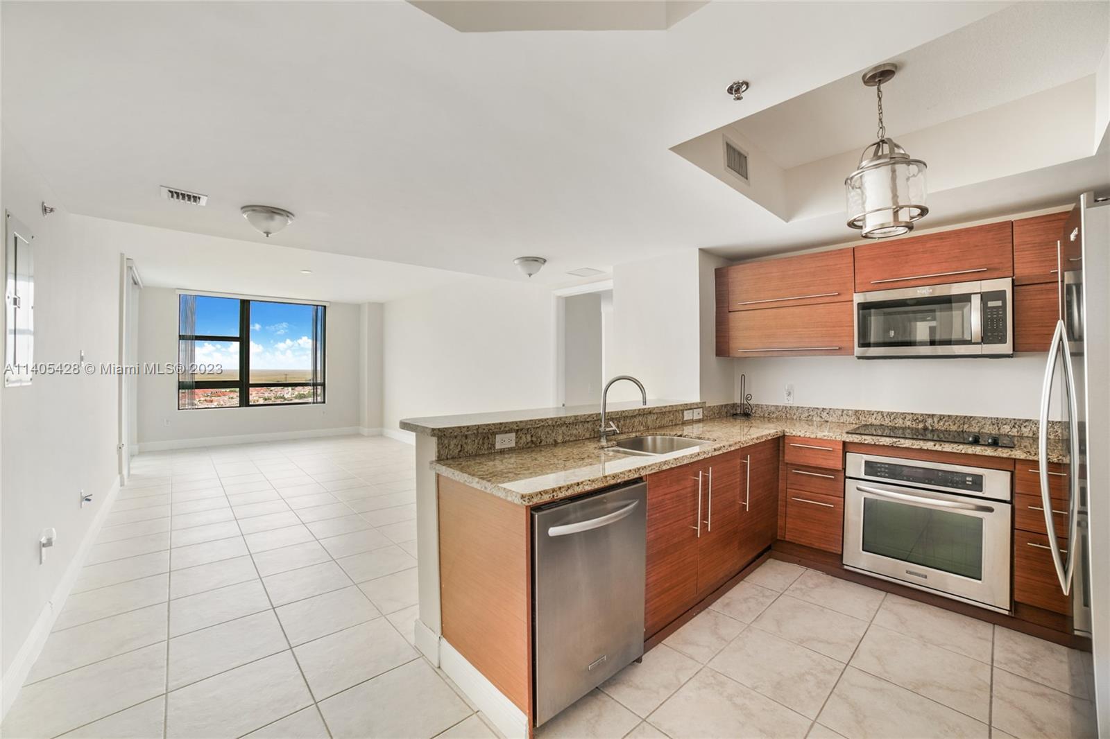 2681 North Flamingo Road, Unit 1906S Sunrise, FL 33323 - Photo 4 of 16 a kitchen with stainless steel appliances granite countertop a stove and a sink