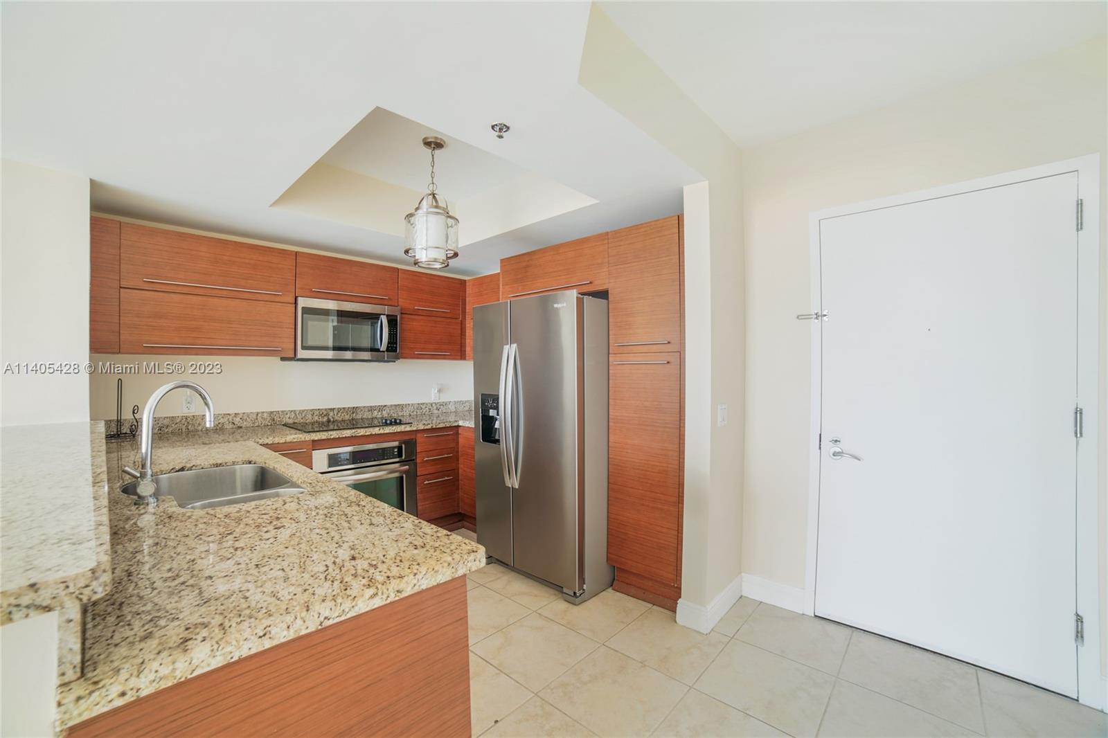 2681 North Flamingo Road, Unit 1906S Sunrise, FL 33323 - Photo 7 of 16 a kitchen with stainless steel appliances granite countertop a sink stove and refrigerator