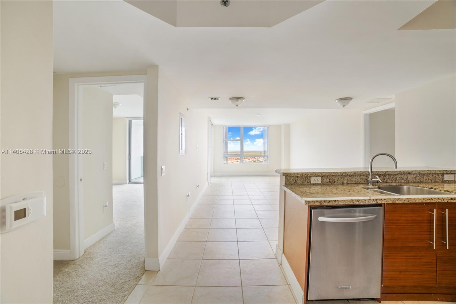 2681 North Flamingo Road, Unit 1906S Sunrise, FL 33323 - Photo 8 of 16 a kitchen with a sink stove and cabinets