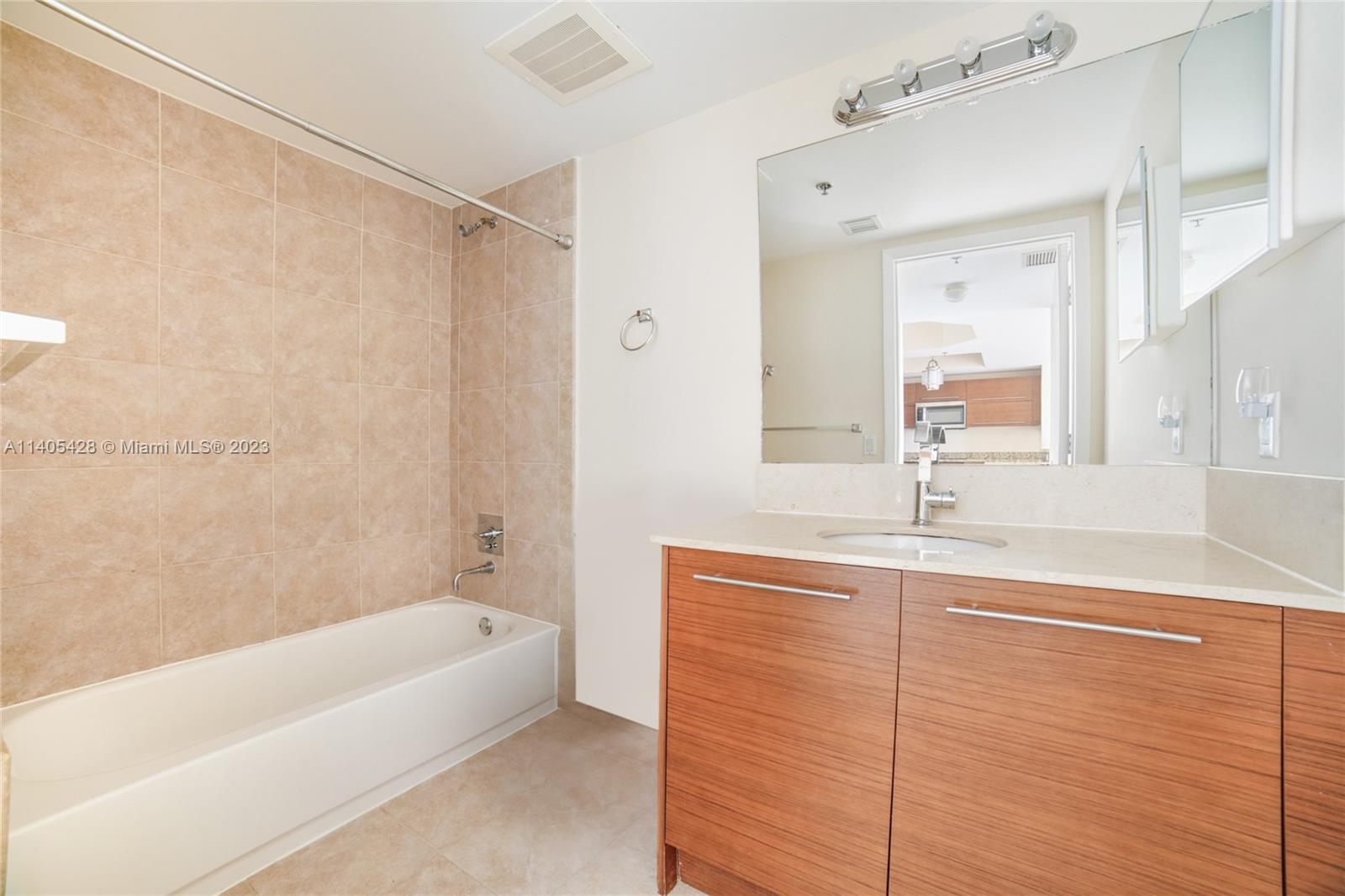 2681 North Flamingo Road, Unit 1906S Sunrise, FL 33323 - Photo 10 of 16 a bathroom with a bathtub a sink and a shower