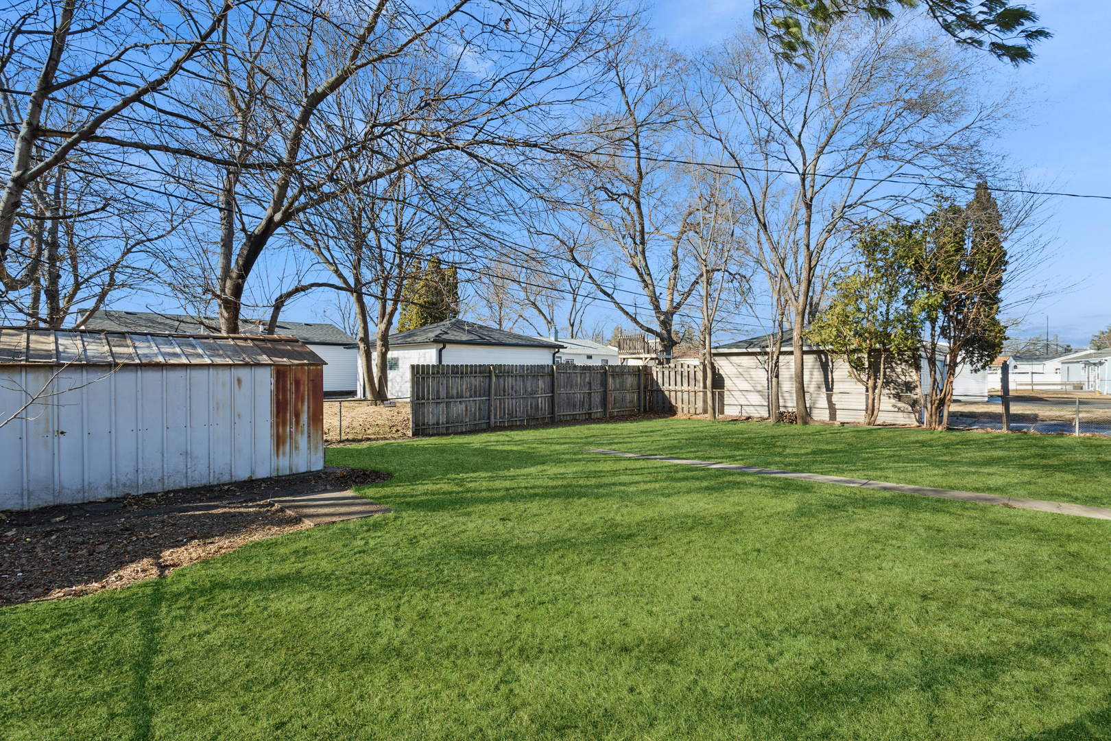516 Dalhart Avenue Romeoville, IL 60446 - Photo 15 of 19 a view of a backyard with large trees