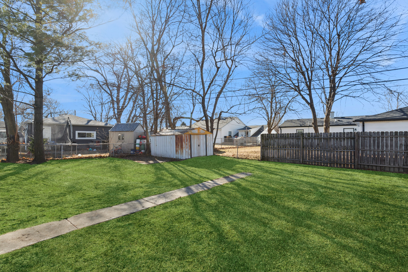 516 Dalhart Avenue Romeoville, IL 60446 - Photo 9 of 19 a view of a backyard with a large tree