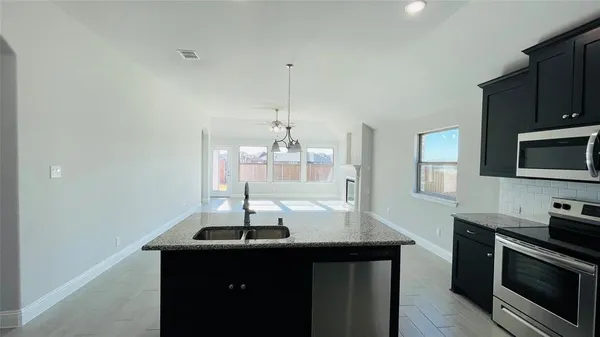 a kitchen with a sink stainless steel appliances and cabinets