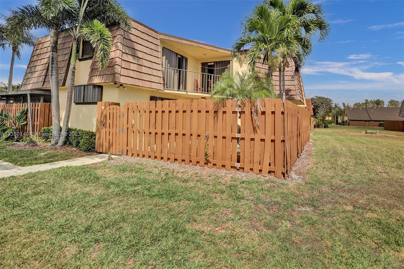 84 Springdale Circle Palm Springs, FL 33461 - Photo 1 of 32 a front view of a house with a yard