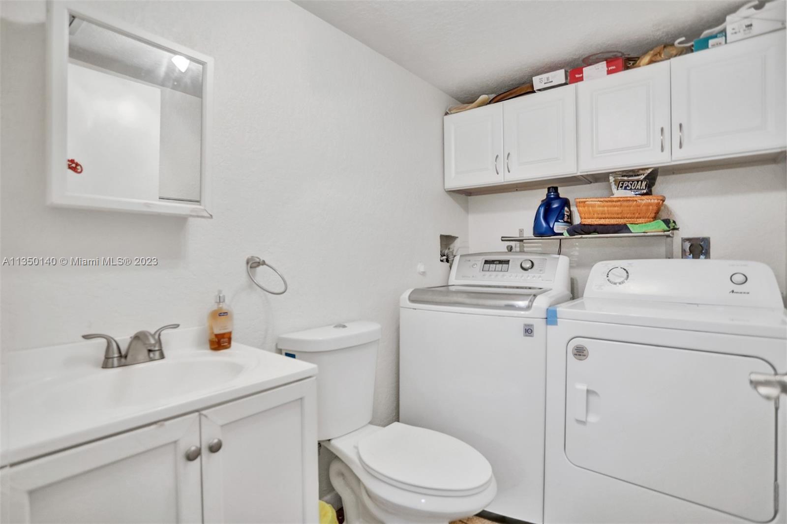84 Springdale Circle Palm Springs, FL 33461 - Photo 12 of 32 a utility room with dryer and washer