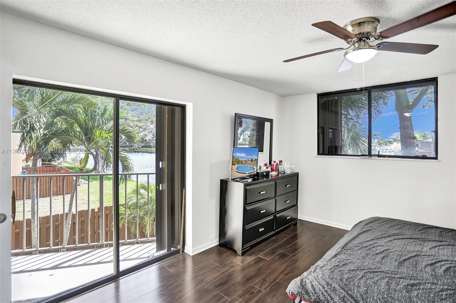 84 Springdale Circle Palm Springs, FL 33461 - Photo 19 of 32 a bedroom with furniture and a large window