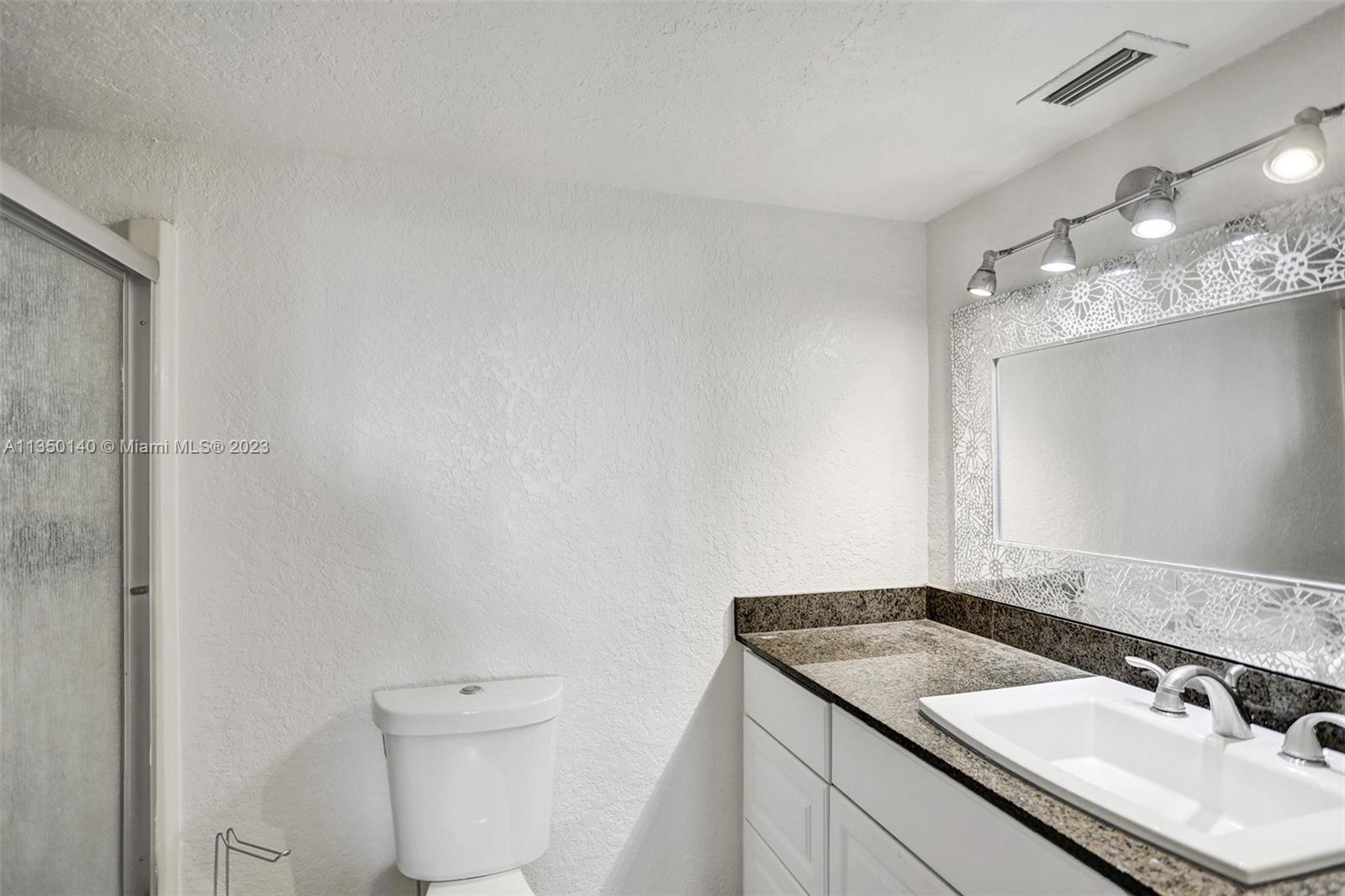 84 Springdale Circle Palm Springs, FL 33461 - Photo 22 of 32 a bathroom with a sink toilet and vanity