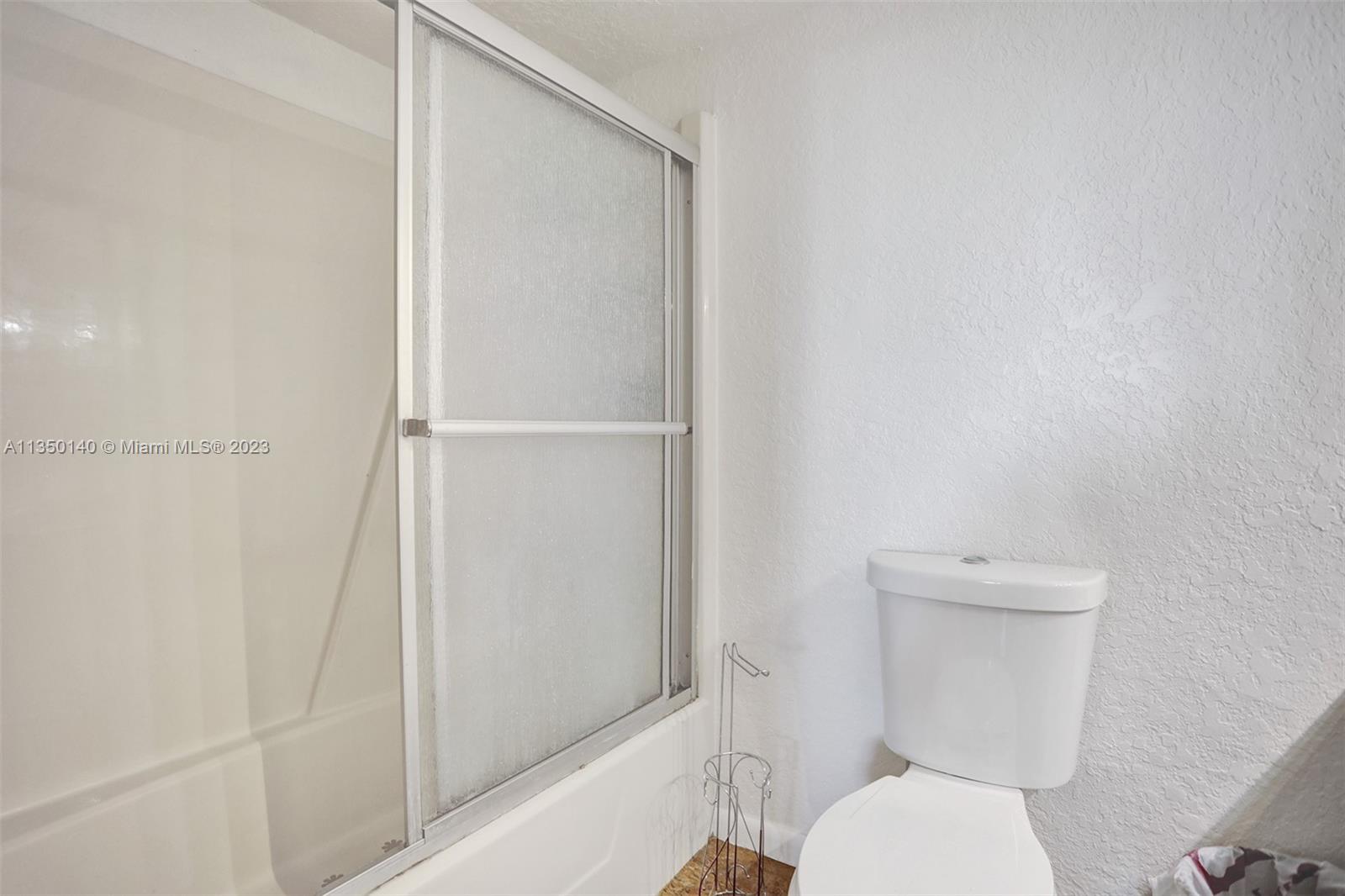 84 Springdale Circle Palm Springs, FL 33461 - Photo 23 of 32 a white toilet sitting next to a shower