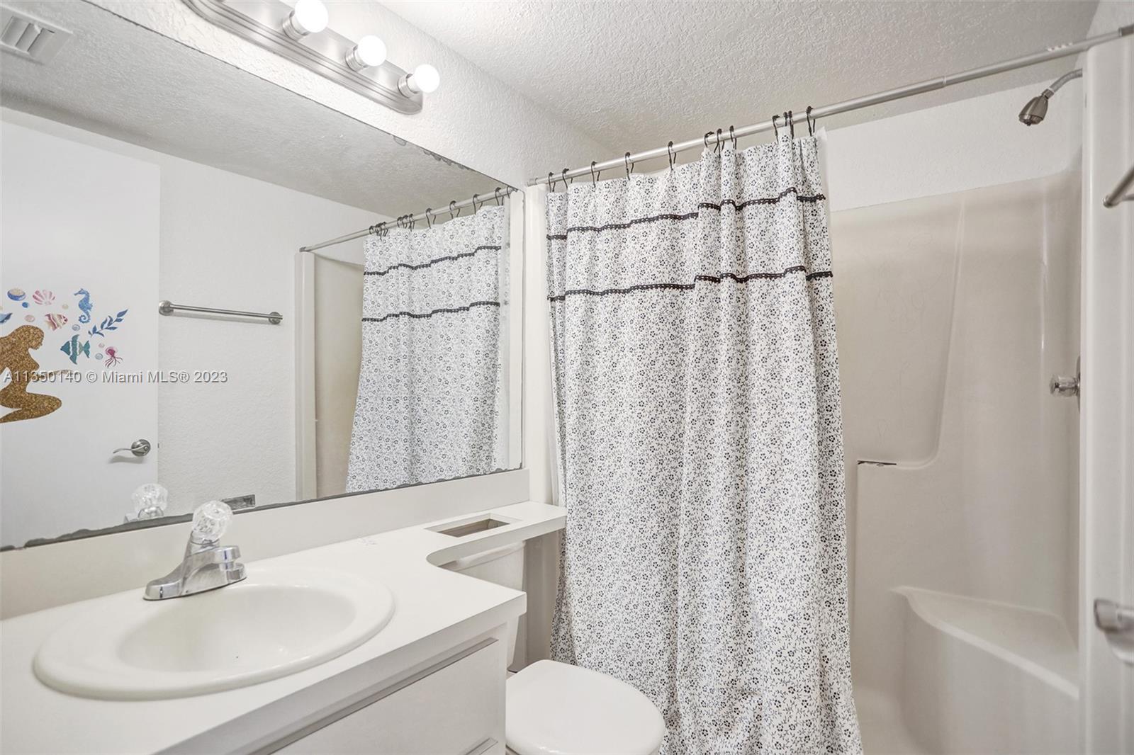 84 Springdale Circle Palm Springs, FL 33461 - Photo 26 of 32 a bathroom with a sink toilet and shower