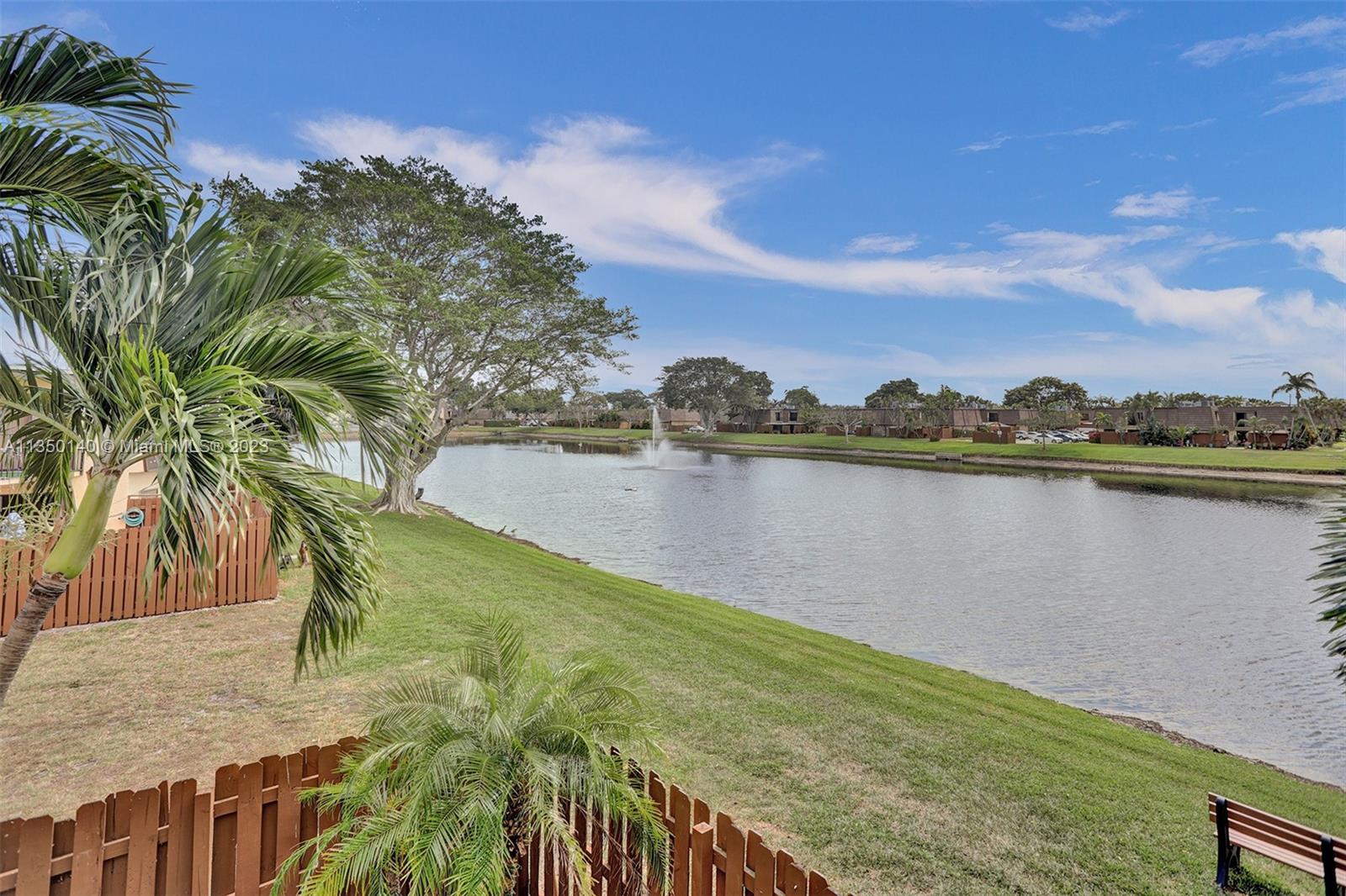 84 Springdale Circle Palm Springs, FL 33461 - Photo 29 of 32 a view of a lake with houses in the back