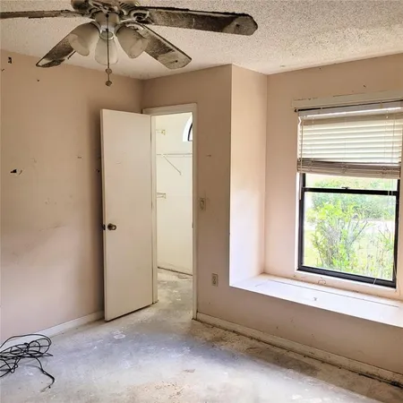 a view of a livingroom with a ceiling fan and window