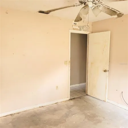 a view of a hallway with a refrigerator and a window