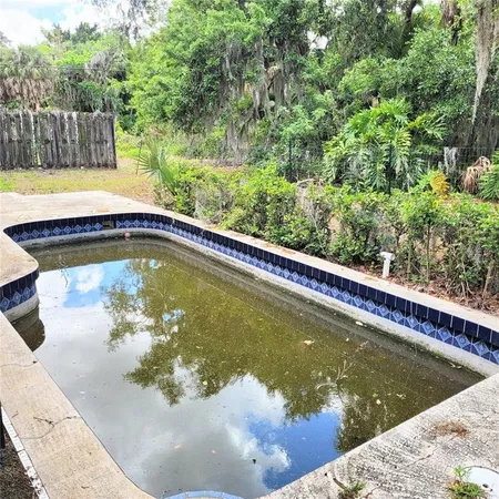 a view of a swimming pool with a outdoor seating
