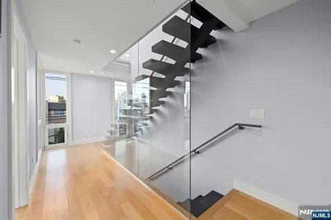 a view of entryway and hall with wooden floor