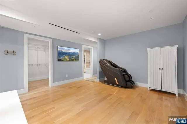 a view of a big room with wooden floor and windows