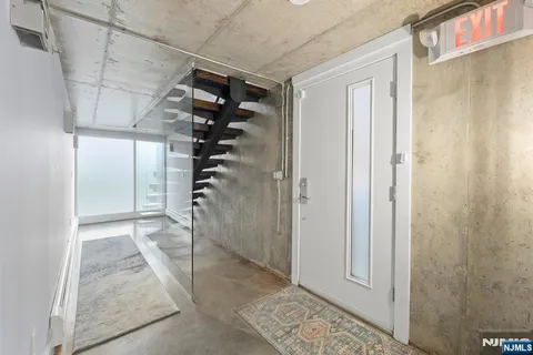 a view of a kitchen with a sink stove cabinets and empty room