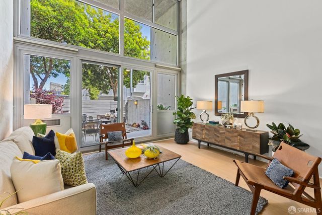 a living room with furniture and a floor to ceiling window